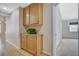 Hallway with wood-style floors and a built-in cabinet with greenery near a bedroom entrance at 1981 Spring Lake Dr, Henderson, NV 89002