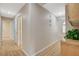 Hallway featuring wood-style floors, white walls, and a storage cabinet with a decorative plant at 1981 Spring Lake Dr, Henderson, NV 89002