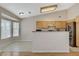 Modern kitchen with stainless steel appliances, granite counters and breakfast bar, and tile floors at 1981 Spring Lake Dr, Henderson, NV 89002