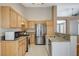 Open kitchen features granite countertops, stainless steel appliances, and lots of natural light at 1981 Spring Lake Dr, Henderson, NV 89002