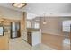 Updated kitchen with stainless steel appliances, granite countertops, tile floors, and open to living area at 1981 Spring Lake Dr, Henderson, NV 89002