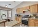 Modern kitchen with granite countertops and stainless steel gas range at 1981 Spring Lake Dr, Henderson, NV 89002