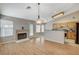 Cozy living room with fireplace, wood floors and easy access to the kitchen and outdoors at 1981 Spring Lake Dr, Henderson, NV 89002