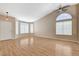 Open-concept living room featuring hardwood floors, vaulted ceilings, and a bay window for natural light at 1981 Spring Lake Dr, Henderson, NV 89002