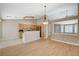 Open-concept living space with wood floors connects kitchen and dining area for easy living at 1981 Spring Lake Dr, Henderson, NV 89002