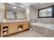 Stylish bathroom with double vanity, framed mirrors, soaking tub, and walk-in shower at 2000 Fashion Show Dr # 2400, Las Vegas, NV 89109