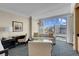 Relaxing bedroom features a desk, couch, sitting area, and large windows with cityscape views at 2000 Fashion Show Dr # 2400, Las Vegas, NV 89109