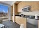 Well-equipped kitchenette with modern appliances, sitting area, and cityscape views at 2000 Fashion Show Dr # 2400, Las Vegas, NV 89109