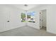 Well-lit bedroom with neutral carpet, two large windows, and white trim around the baseboards at 2105 Madagascar Ln, Las Vegas, NV 89117