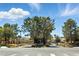 Well-maintained Canyon Ridge community entrance with lush landscaping and blue skies overhead at 2105 Madagascar Ln, Las Vegas, NV 89117