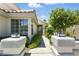 Charming home entrance with mature landscaping and decorative lighting fixtures at 2105 Madagascar Ln, Las Vegas, NV 89117