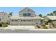 Traditional two-story home with a three-car garage and manicured front yard at 2105 Madagascar Ln, Las Vegas, NV 89117