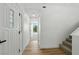 Bright hallway with hardwood floors and white doors leads to a view of lush green trees outside at 2105 Madagascar Ln, Las Vegas, NV 89117
