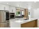 Bright kitchen boasts stainless steel appliances, white cabinets, and an island with a sink at 2105 Madagascar Ln, Las Vegas, NV 89117
