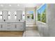 A modern main bathroom featuring a dual vanity, a walk-in shower and a view of the outside at 2105 Madagascar Ln, Las Vegas, NV 89117