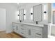Contemporary main bathroom featuring dual mirrors, a modern vanity with double sinks, and stone shower at 2105 Madagascar Ln, Las Vegas, NV 89117