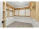 Walk-in closet with wooden shelving and racks for ample storage space in a carpeted area at 2105 Madagascar Ln, Las Vegas, NV 89117