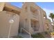 Building exterior featuring stacked balconies, neutral color palette, and desert landscaping at 2243 Aspen Mirror Way # 102, Laughlin, NV 89029