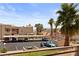 View of condo complex with covered parking and desert landscaping with palm trees at 2243 Aspen Mirror Way # 102, Laughlin, NV 89029