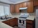 Functional kitchen with oak cabinets, laminate countertops, and white appliances at 2243 Aspen Mirror Way # 102, Laughlin, NV 89029