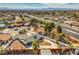 View of single-story home with spacious backyard nestled in a tranquil neighborhood setting at 2450 Tournament St, Las Vegas, NV 89142