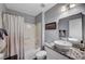 Bathroom featuring a modern vanity, mirror, granite countertop, and shower over tub at 2456 Desert Butte Dr, Las Vegas, NV 89134
