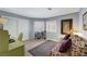 This bedroom could double as an office featuring laminate floors, a love seat, and bright light at 2456 Desert Butte Dr, Las Vegas, NV 89134