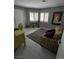 Cozy bedroom/office with a comfortable sofa, desk, and ample natural light at 2456 Desert Butte Dr, Las Vegas, NV 89134