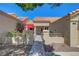 Inviting front courtyard featuring a tranquil seating area under a red umbrella and secure wrought-iron gate at 2456 Desert Butte Dr, Las Vegas, NV 89134