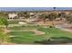 Elevated golf course showcasing bunkers, greens, a winding cart path, and homes in the distance at 2456 Desert Butte Dr, Las Vegas, NV 89134