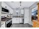 Well-lit kitchen with stainless steel appliances, granite countertops, and white cabinetry at 2456 Desert Butte Dr, Las Vegas, NV 89134