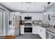 Modern kitchen with stainless steel appliances, granite countertops, and sleek white cabinetry at 2456 Desert Butte Dr, Las Vegas, NV 89134