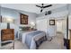 This main bedroom has a bed, a ceiling fan and ensuite bathroom at 2456 Desert Butte Dr, Las Vegas, NV 89134