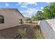 Expansive backyard featuring gravel landscaping, mature trees, and a white block wall at 2512 Huber Heights Dr, Las Vegas, NV 89128