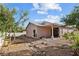 Spacious backyard with gravel landscaping, patio and lush green trees at 2512 Huber Heights Dr, Las Vegas, NV 89128