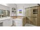 Stylish bathroom featuring a soaking tub, glass enclosed shower and modern finishes at 2512 Huber Heights Dr, Las Vegas, NV 89128