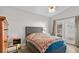 Cozy bedroom with hardwood floors, a tufted headboard, and patio access, creating a serene and relaxing retreat at 2512 Huber Heights Dr, Las Vegas, NV 89128