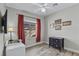 Cozy bedroom with wood floors, neutral walls, dark wood furniture, and a bright window at 2512 Huber Heights Dr, Las Vegas, NV 89128