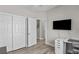 Modern bedroom featuring wood floors, closet space, and a wall-mounted television at 2512 Huber Heights Dr, Las Vegas, NV 89128