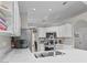 Bright kitchen with stainless steel appliances, ample white cabinetry, and a sink enhances the space at 2512 Huber Heights Dr, Las Vegas, NV 89128