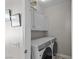 Convenient laundry room featuring a modern washer and dryer with white cabinets at 2512 Huber Heights Dr, Las Vegas, NV 89128