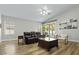 Inviting living room features wood floors, modern furniture, and access to outdoor space at 2512 Huber Heights Dr, Las Vegas, NV 89128