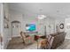 Bright living room with hardwood floors, comfortable seating, and a large TV area creates an inviting atmosphere at 2512 Huber Heights Dr, Las Vegas, NV 89128