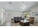 Spacious living room with hardwood floors, comfortable seating, and sliding doors enhances the inviting atmosphere at 2512 Huber Heights Dr, Las Vegas, NV 89128
