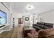 Spacious living room with hardwood floors, comfortable seating, and a large media center creates an inviting atmosphere at 2512 Huber Heights Dr, Las Vegas, NV 89128