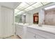Bathroom with double sinks, modern vanity, and mirrored wall with lighting at 2723 Seabridge Dr, Las Vegas, NV 89121