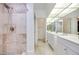 Bright bathroom with double sink vanity, large mirrors, and shower stall at 2723 Seabridge Dr, Las Vegas, NV 89121