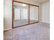 Bedroom with closet featuring sliding mirrored doors and neutral carpet at 2723 Seabridge Dr, Las Vegas, NV 89121
