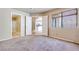 Bedroom features neutral carpet, natural light, and an entry to the bathroom at 2723 Seabridge Dr, Las Vegas, NV 89121
