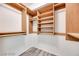 Walk-in closet with wood shelving and hanging rods for optimal organization at 2723 Seabridge Dr, Las Vegas, NV 89121